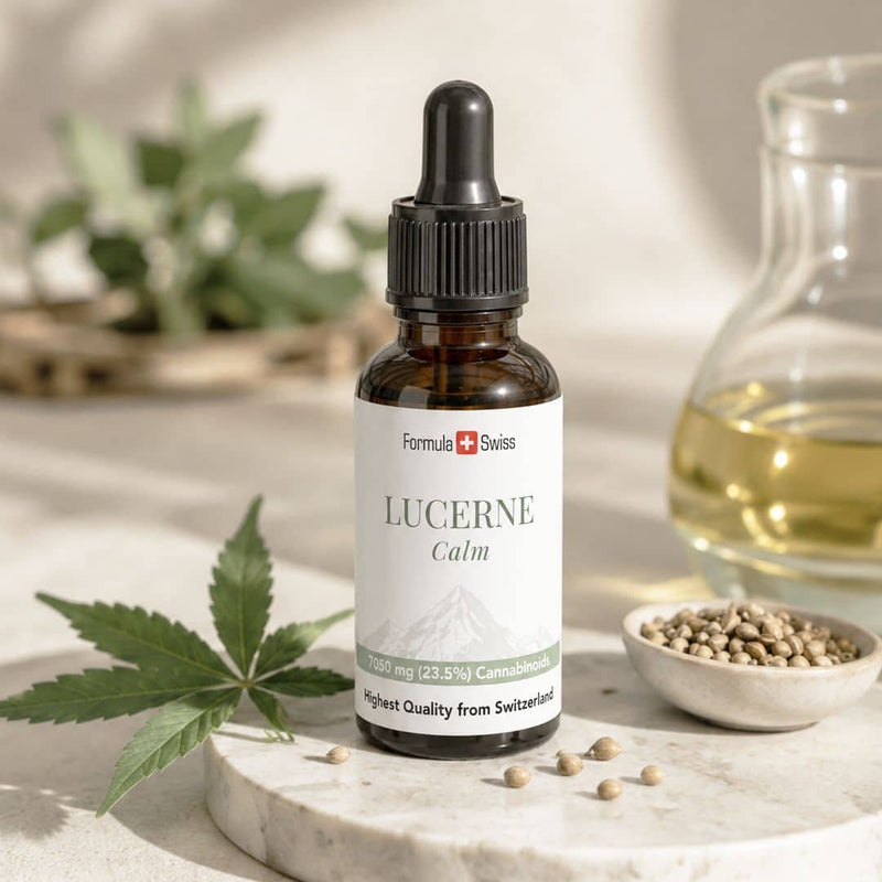 Formula Swiss Lucerne Calm CBD oil bottle with hemp leaves, hemp seeds and golden botanical oil.